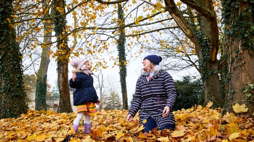 Family exploring gardens in autumn